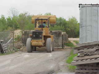 Front loader feeding sand mixture.