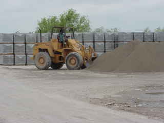 Front loader mixing sand.