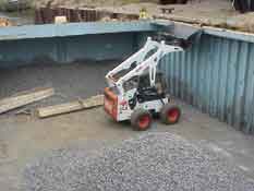Bobcat inside barge.
