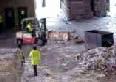 Forklift moving bale.