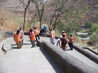 Yolanda carried by porters.